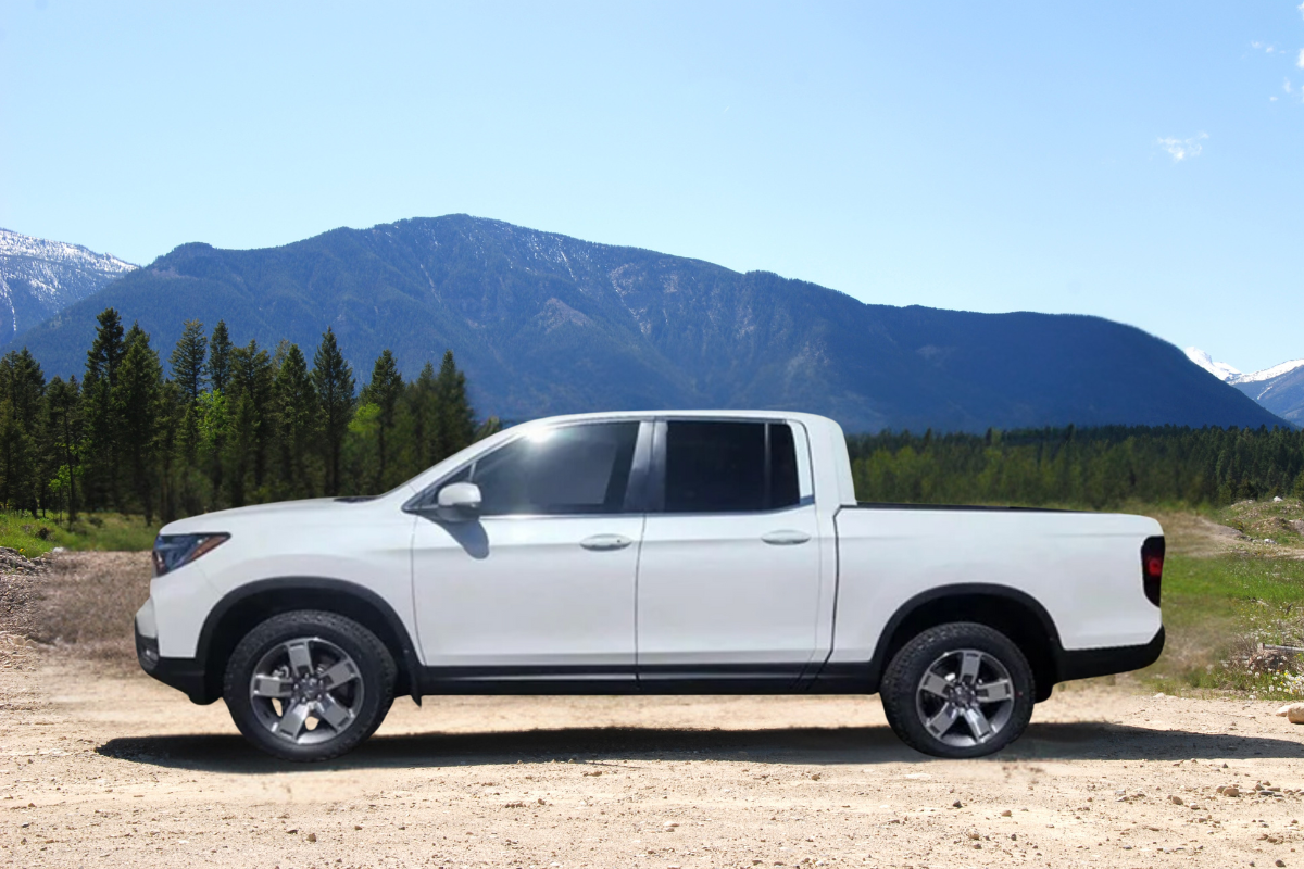 Honda Ridgeline truck parked on dirt road against mountain backdrop