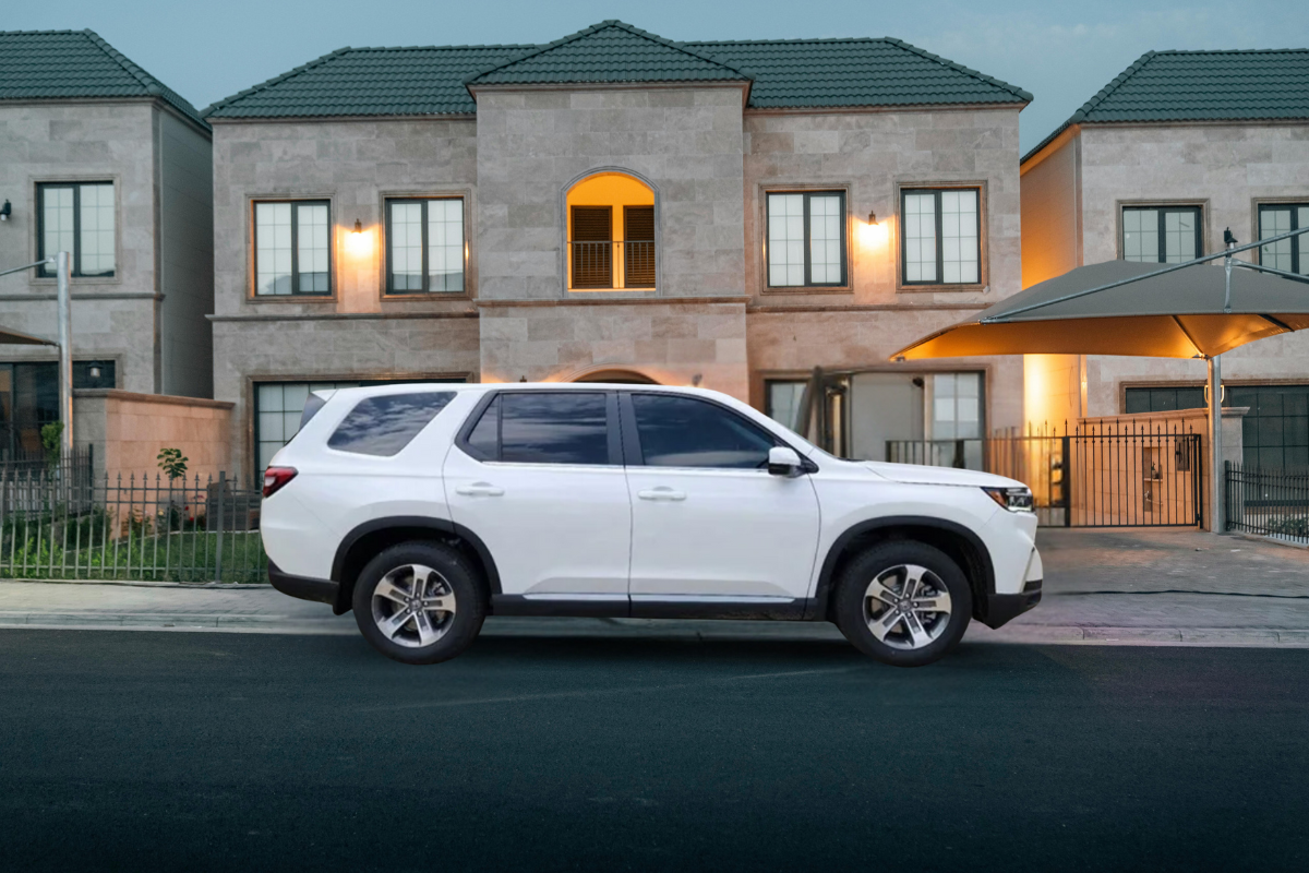 2025 Honda Pilot EX-L in white color parked in front of apartment complex