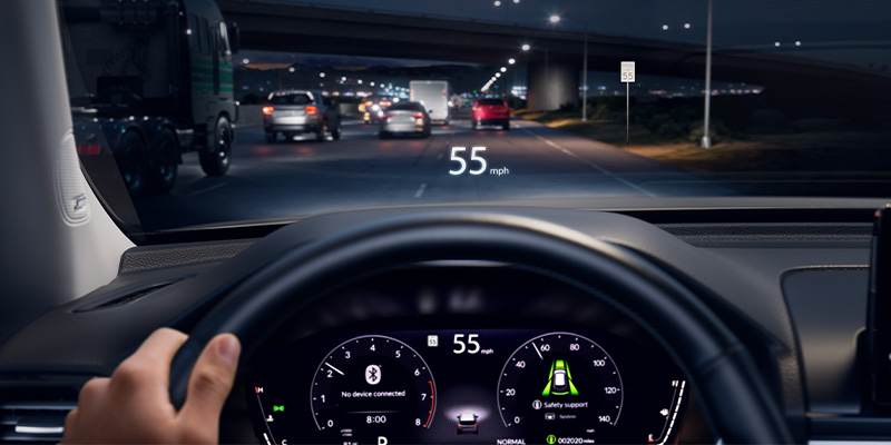 A 2026 Honda Pilot dashboard displaying speed as 55 mph, with a view of traffic at night.