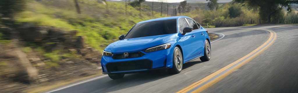 a blue 2026 Honda Civic Sedan Hybrid drives in Denver, CO