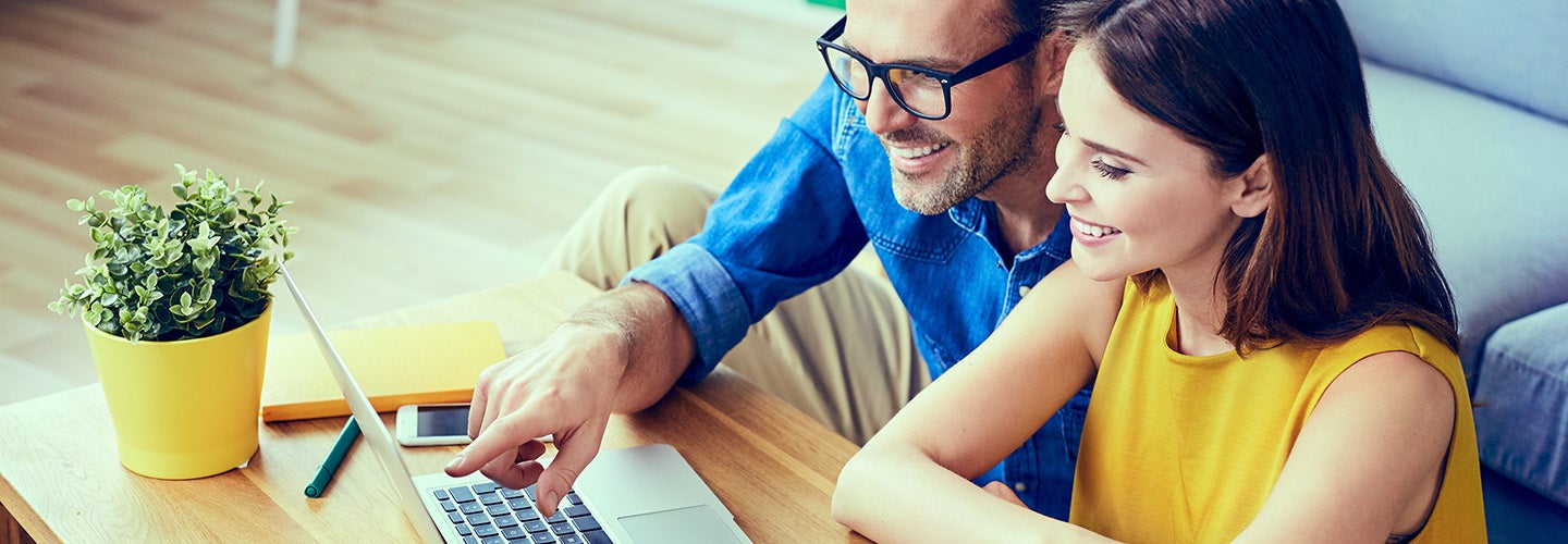 A couple looking at a laptop